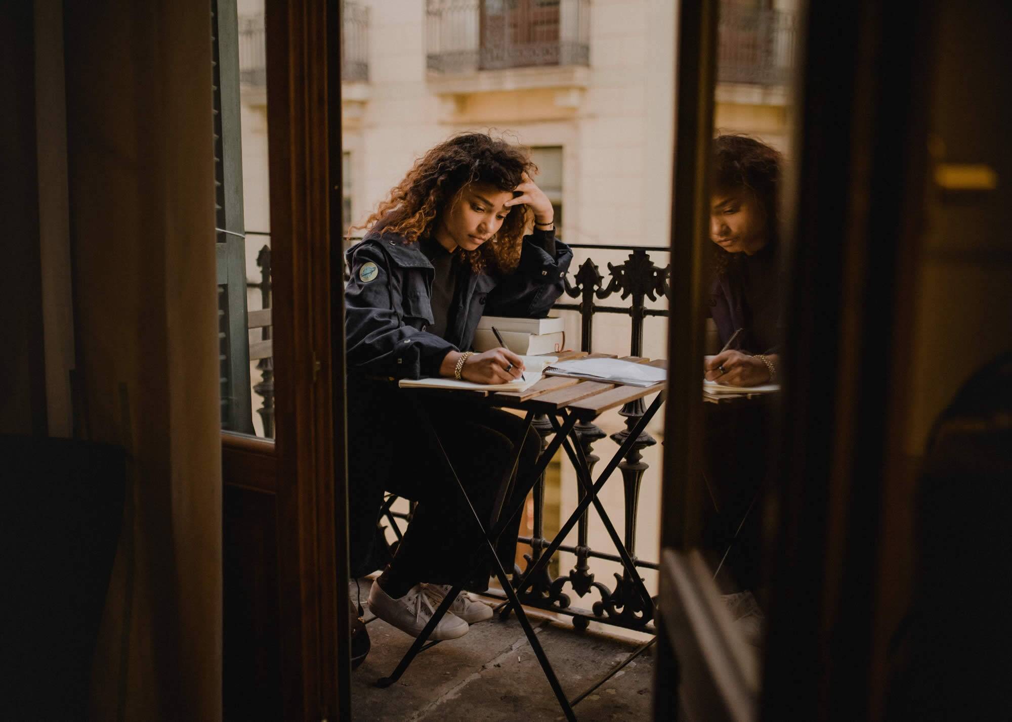 student writing her reflective essay